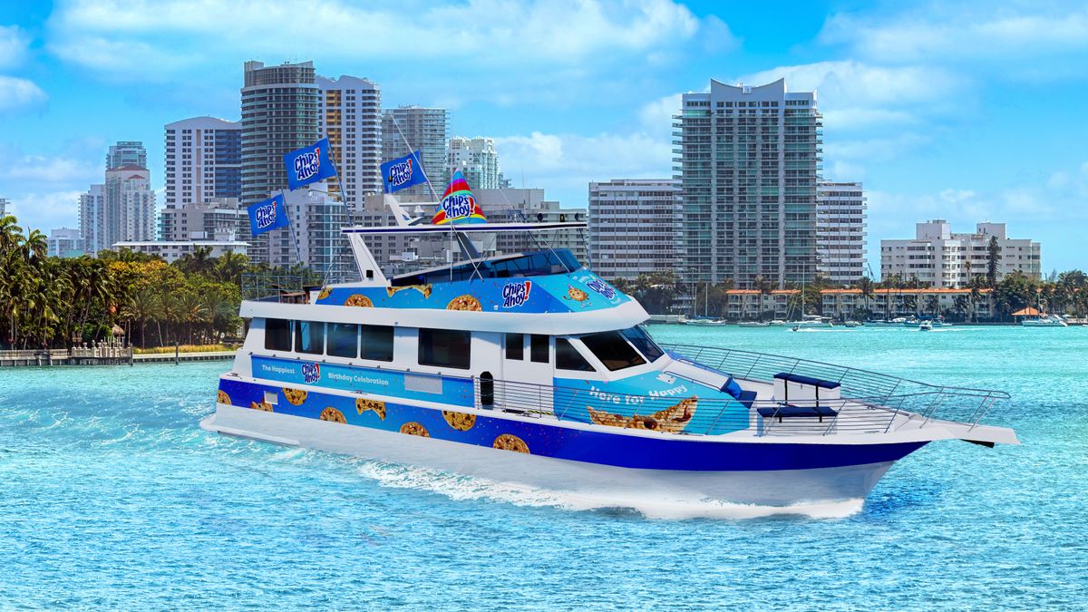 A Chips Ahoy! themed yacht motors through a harbor