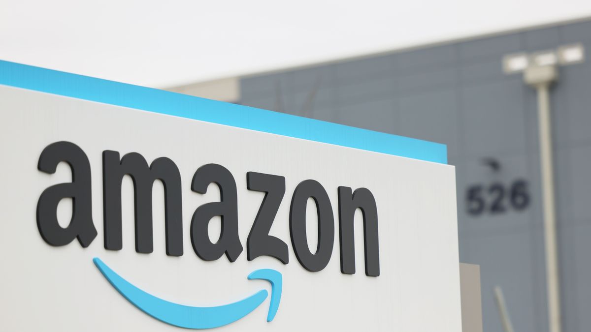 An Amazon sign is seen with a building in the background