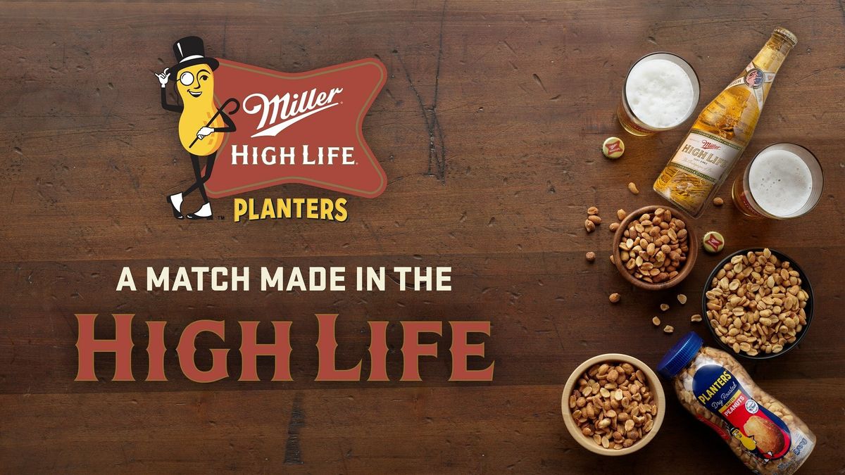 Miller High Life next to peanuts against a wood background.