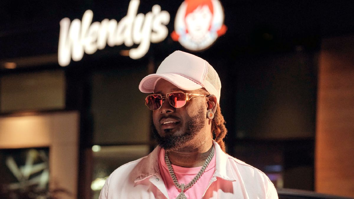 T-Pain stands in front of a Wendy's
